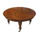 LARGE NINETEENTH-CENTURY MAHOGANY D-END DINING TABLE with three extending leaves, raised on turned