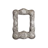 EDWARDIAN EMBOSSED SILVER PHOTO FRAME with cherub decoration 211 x 16 cm.