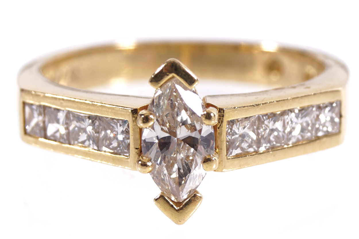 18 CT. YELLOW GOLD MOUNTED RING set with marquise cut diamond weighing .52 ct. having four