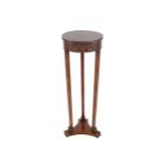 EDWARDIAN PERIOD MAHOGANY ADAM TORCHERE with circular bell petal husk moulded border, above an urn