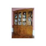 GEORGE III STYLE WALNUT AND BOXWOOD INLAID BREAKFRONT BOOKCASE the superstructure with a moulded