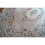 LARGE CHINESE RUG of oval form 280 x 185 cm.