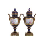 NINETEENTH-CENTURY ORMOLU MOUNTED SEVRES URNS AND COVERS each of baluster form, with mask stemmed