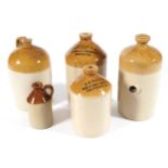 GROUP OF GLAZED TERRACOTTA WHISKEY JARS TOGETHER WITH A FOOT WARMER 34cm and lower