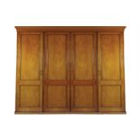 LARGE NINETEENTH-CENTURY MAHOGANY WARDROBE the moulded crown above four panelled doors, enclosing