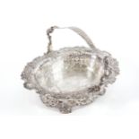 A FINE PIERCED IRISH SILVER BASKET, JOHN HAMILTON, DUBLIN 1736 A superb swing handled oval flower,