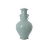 CHINESE BALUSTER-SHAPED VASE OF ARCHAIC FORM in a pale sea-green celadon glaze, with elephant head