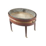 GEORGE III PERIOD MAHOGANY AND BRASS BOUND WINE CELLERETT of oval form, with metal lined interior,