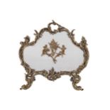 NINETEENTH-CENTURY ROCOCO ARMORIAL SHAPED BRASS FIRE SCREEN raised on scroll ends 71 x 75 cm.