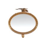 REGENCY PERIOD CARVED GILT WOOD OVER MANTLE MIRROR, CIRCA 1820 the oval plate within a bobbin