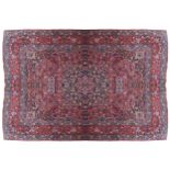 SOUTHEAST PERSIAN CARPET red border, ivory and navy cartouches 348 x 257 cm.