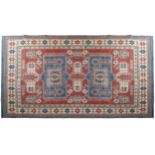 SOUTH CAUCASIAN KAZAKH CARPET ivory border, two rectangular blue medallions 323 x 234 cm.