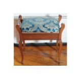 EDWARDIAN PIANO STOOL the upholstered lift-up seat between scroll ends, raised on cabriole legs 60