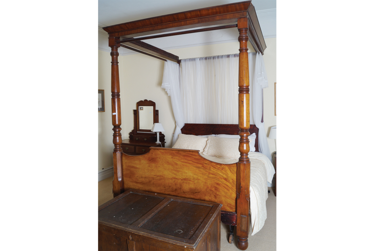 WILLIAM IV PERIOD MAHOGANY FOUR POSTER BED the moulded edged canopy, raised on turned pillars,