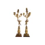 PAIR OF ORMOLU EMPIRE PERIOD CHERUB STEMMED CANDELABRAS each of four lights 49 cm. high (2)