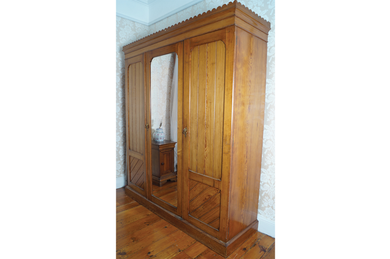 NINETEENTH-CENTURY AESTHETIC REVIVAL PINE THREE DOOR WARDROBE with central mirror door 186 cm. wide;