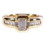 18 CT. YELLOW GOLD MOUNTED RING set with an emerald cut diamond weighing 0.62 ct. and 12 baguette