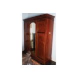 EDWARDIAN MAHOGANY AND INLAID WARDROBE the moulded crown above a central mirror door flanked by a