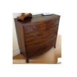 REGENCY PERIOD MAHOGANY CHEST of two short and three long drawers, furnished with oval brass