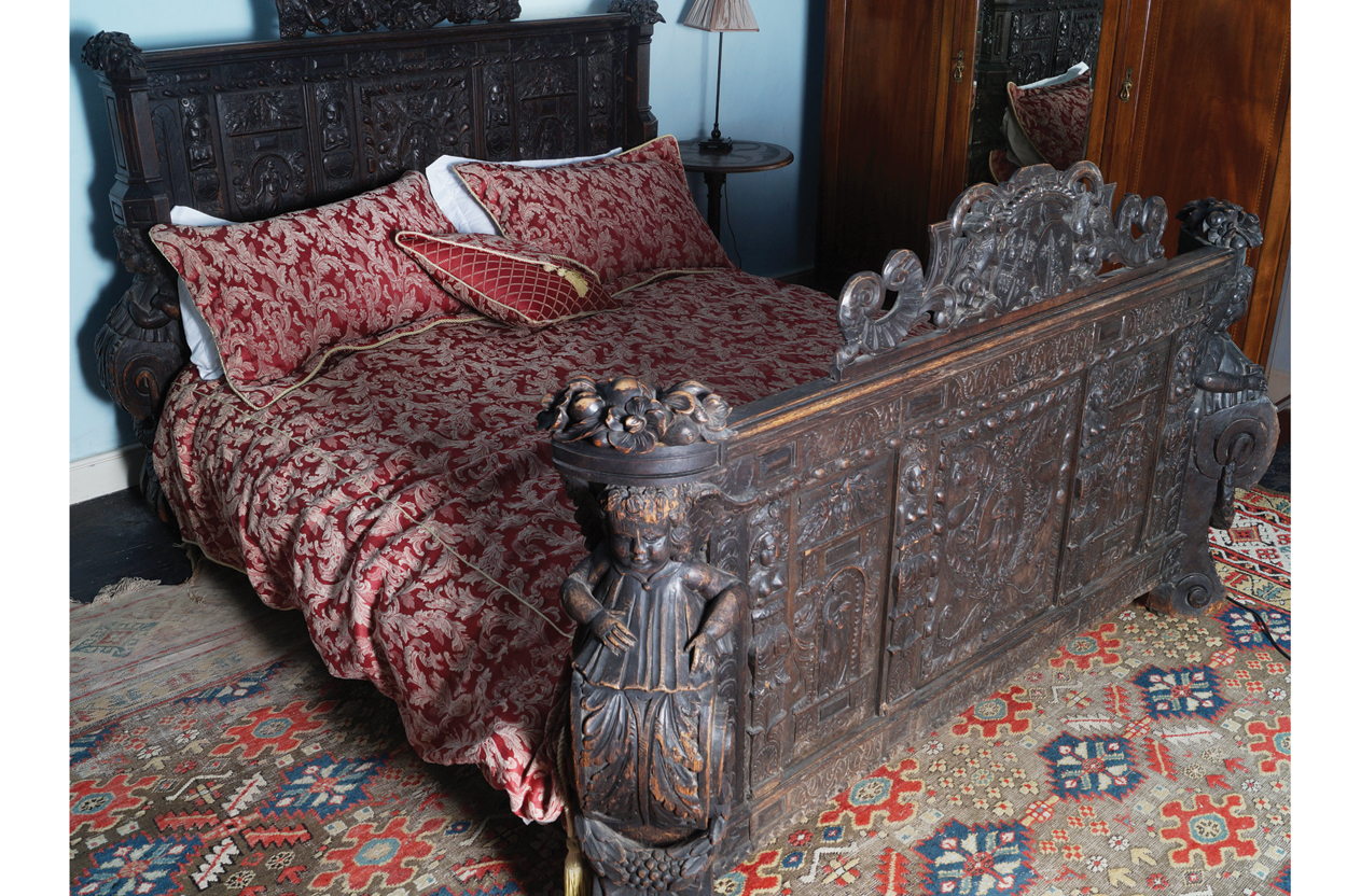 MAGNIFICENT NINETEENTH-CENTURY CARVED OAK FRAMED MARRIAGE BED with profuse figure carved panels,