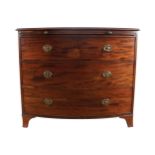 GEORGE III PERIOD MAHOGANY BOW FRONT CHEST of three drawers, below a brushing slide, raised on