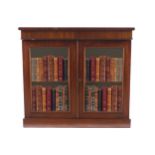 REGENCY PERIOD MAHOGANY DWARF BOOKCASE the rectangular top, above a conforming frieze, over two
