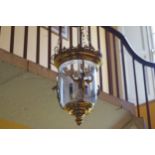 LATE TWENTIETH-CENTURY GRIFFIN MOUNTED BRASS HALL LANTERN of circular glazed form 86 cm. high; 36