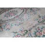 LARGE CHINESE CARPET on cream ground with floral decoration 555 x 373 cm.