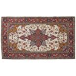 NORTHEAST PERSIAN RUG ivory ground, central medallion, red border 124 x 184 cm.