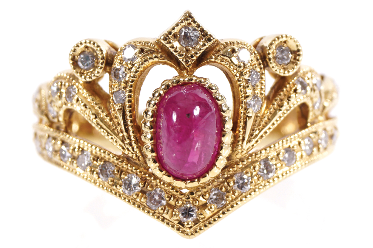 18 CT. YELLOW GOLD MOUNTED RING crown shaped with pave set diamonds and a cabochon ruby