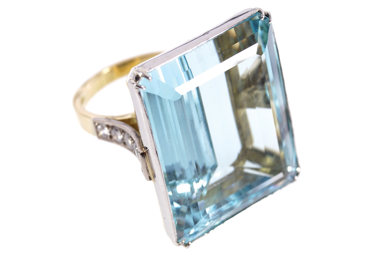 PLATINUM AND 18 CT. GOLD MOUNTED RING set with an emerald cut aquamarine weighing 55 ct. and