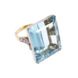 PLATINUM AND 18 CT. GOLD MOUNTED RING set with an emerald cut aquamarine weighing 55 ct. and