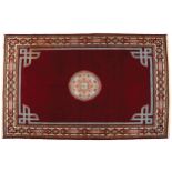 HANDMADE CARPETon red ground, with central medallion and border296 x 196 cm.