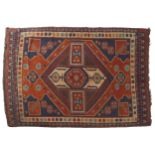 CAUCASIAN RUG, CIRCA 1900of camel wool, on red ground with navy spandrels147 x 215 cm.