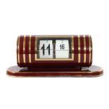 Klappzahlen-Tischuhr Wohl Kienzle, 1950er Jahre, auf längsovalem Stand montierte zylindrische Uhr,