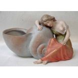 An Austrian porcelain figural vase in the form of a scantily clad maiden resting against a conch