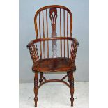 A 19th century high back Windsor armchair with crinoline stretcher