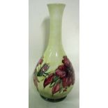 A William Moorcroft pottery bottle vase, tubeline decorated with a band of hibiscus blooms against a