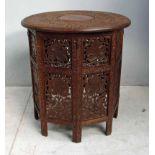 A late 19th century Indian table, the circular top with central brass inlaid decoration above an