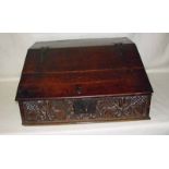 A 17th century carved oak bible box with sloping hinged lid enclosing three drawers, with tulip