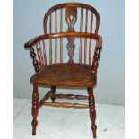 A 19th century yew wood Windsor chair with pierced splat, spindle supports and joined by a double