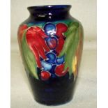 A William Moorcroft leaf and berry vase on a green ground, Moorcroft mark and Made in England