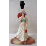 An Art Deco onyx table lamp set with a Lawton porcelain figure of a lady with an umbrella, Muriel,