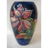 A large William Moorcroft pottery vase, ovoid form, tubeline decorated in a clematis version on