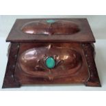 An Arts and Crafts copper coal box of rectangular tapering form with hinged lid, front, side and top