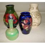 A group of four Moorcroft vases comprising an Anemone pattern vase, a Lily pattern vase, a small