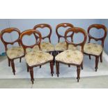 A set of six Victorian balloon back mahogany dining chairs with serpentine shaped stuff over seats