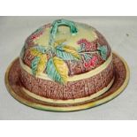 A Mintons majolica muffin dish and cover decorated with blackberries and foliage on a yellow ground,