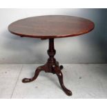 A George III mahogany tilt top table on turned column support and pad feet, 90cm dia