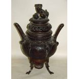 A large bronze Chinese two-handled Koro and cover, the pierced circular cover surmounted by a seated